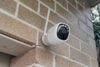 Reolink Altas security camera on brick wall
