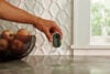 Arlo Indoor Essential security camera being placed by hand