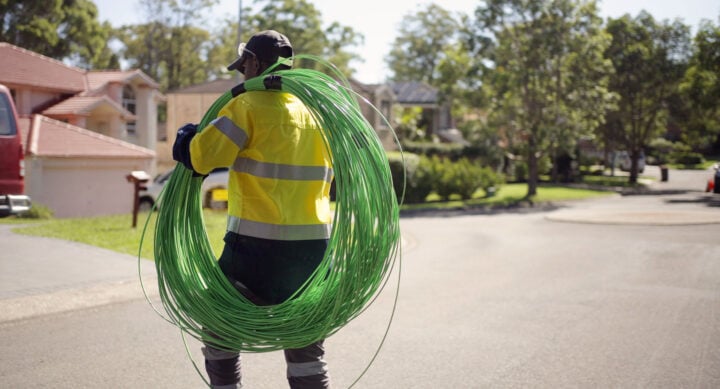NBN worker carrying fibre cable