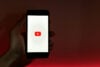YouTube logo on phone dark background stock image