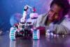 A child playing with a Lego Outpost Moon Rover Space Vehicle
