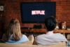 Couple on couch watching Netflix stock image