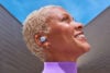 Google Pixel Buds 2a model smiling to the sky