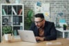 Man at laptop looking impressed
