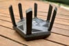 Asus RT-AXE7800 router on wooden flooring