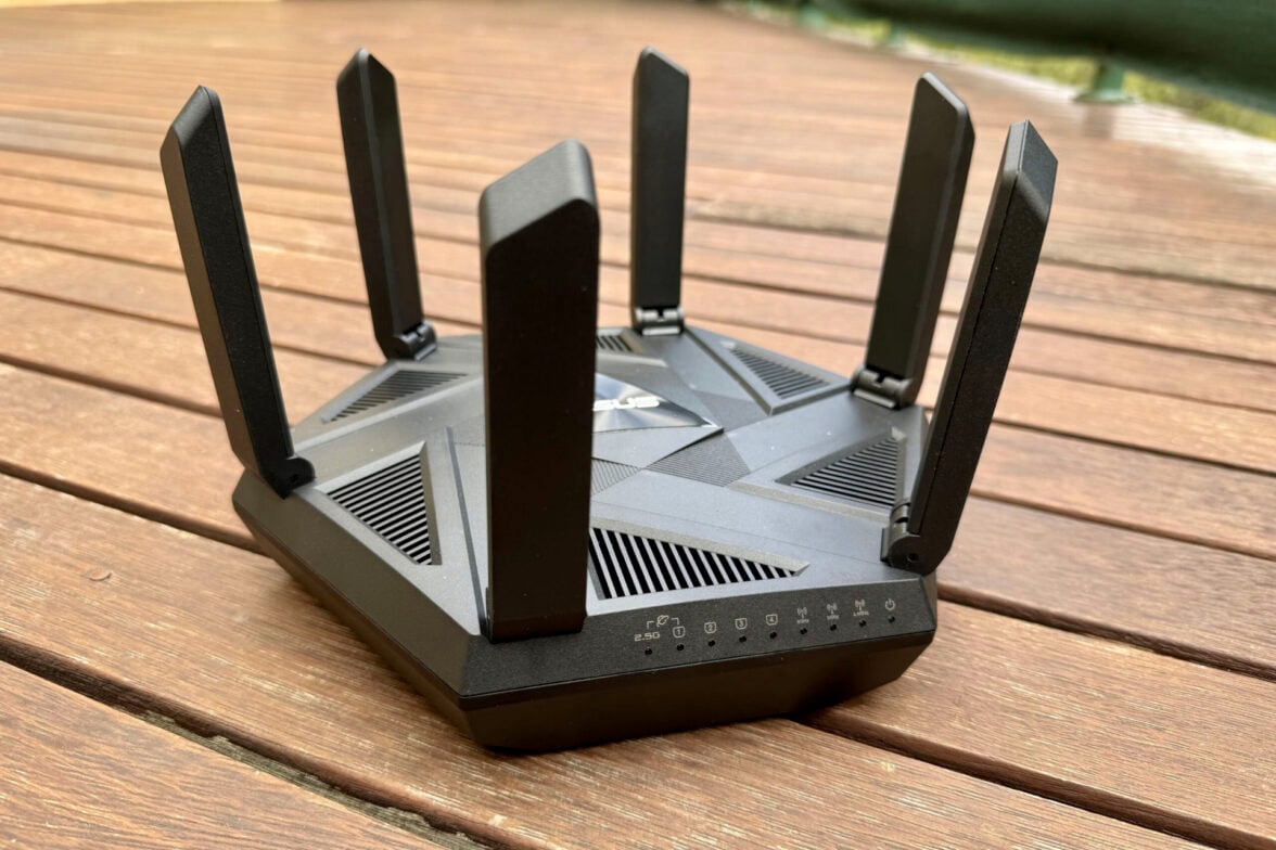 Asus RT-AXE7800 router on wooden flooring