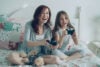 Mother and daughter playing video games together