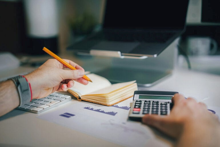 Person doing calculations stock image