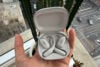 Shokz OpenFit 2+ in case held in hand
