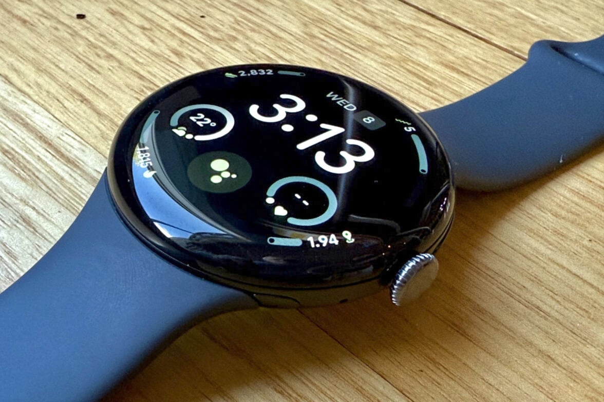 Google Pixel Watch 4 on a wooden surface