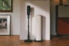 Roborock H60 Hub Ultra vacuum and dock standing against white wall
