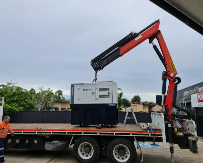 Vodafone backup generator lifted by crane