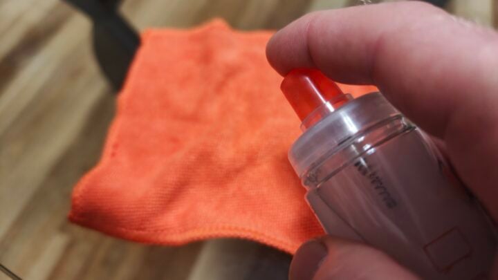 Spray the cloth first