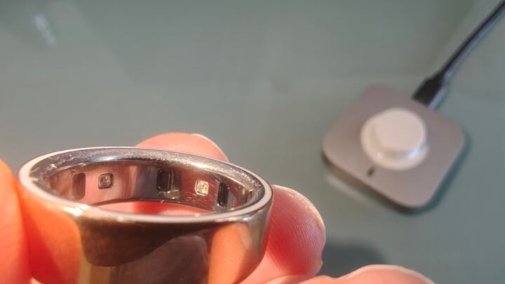 Oura Ring sensors and charger in background