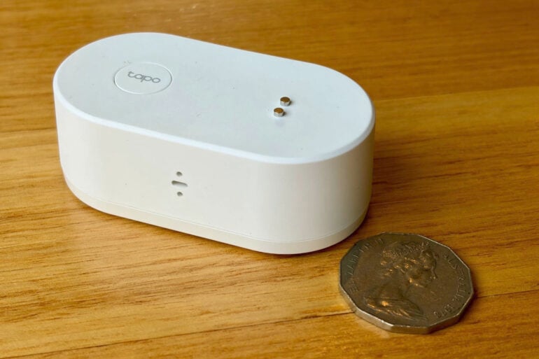 Tapo T300 Smart Water Leak Sensor next to 50c coin