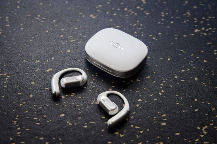 Shokz OpenFit Pro white headphones on dark speckled surface