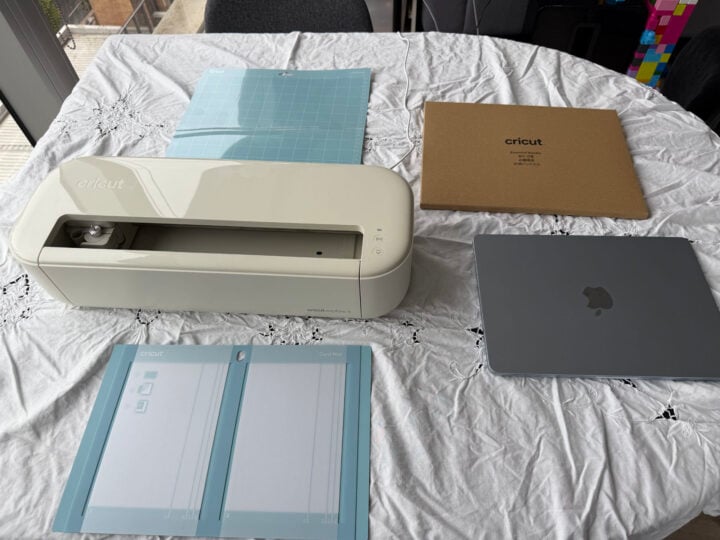 Cricut Explore 5 with cutting mats and MacBook