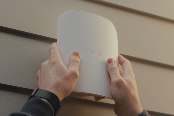 Eero Outdoor 7 router being placed on wall