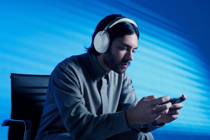 Man using phone while wearing Sony 1000X THE COLLEXION headphones