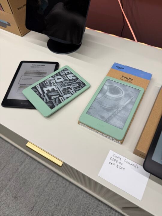 Kindle e-readers on display including the new Colorsoft with a handwritten $278 price note