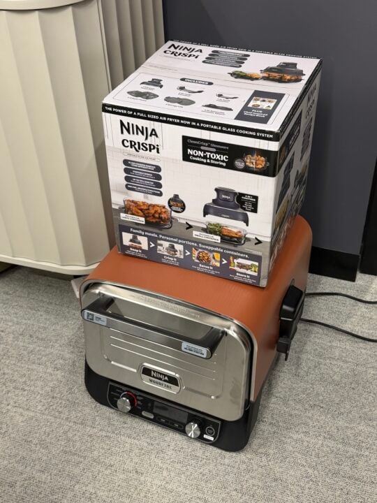 Ninja Crispi air fryer box sitting on a copper Ninja pizza oven