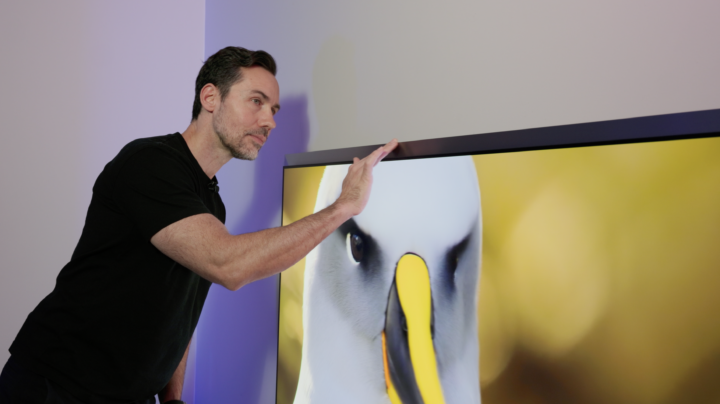 Val Quinn inspecting Samsung OLED S95H 4K TV silver border