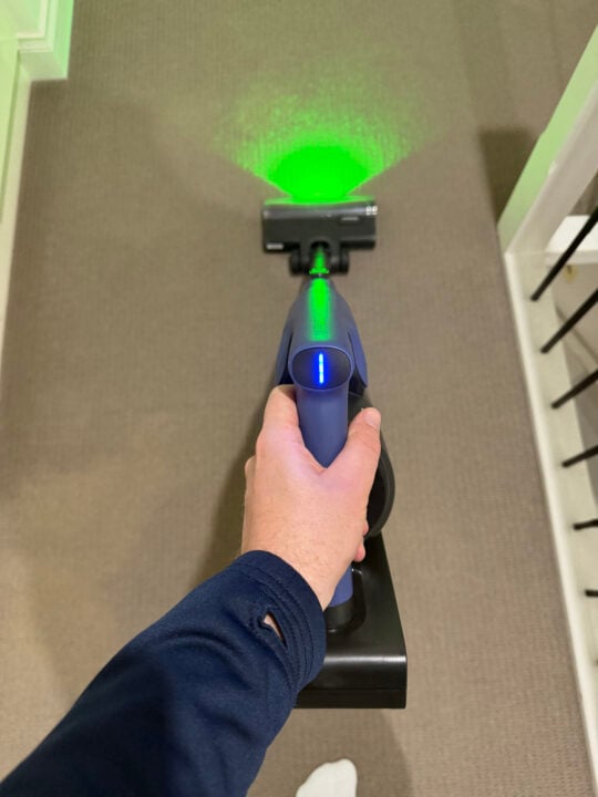 POV of holding a vacuum which has a thin light bar on the handle