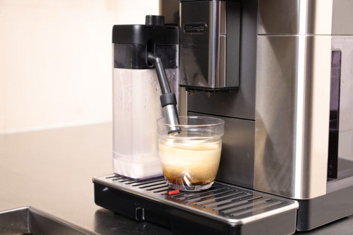 Filling up a flat white with milk