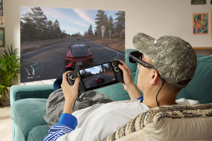 Man playing ROG Xbox Ally X20 with AR glasses
