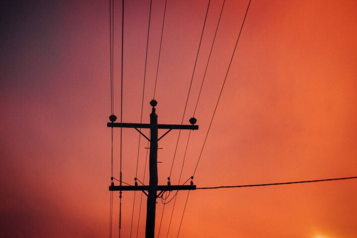 Power lines orange sky stock image