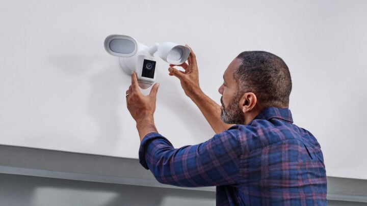 Man installing Ring floodlight camera