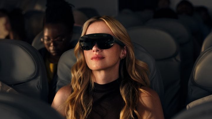 Person wearing VR glasses on plane/