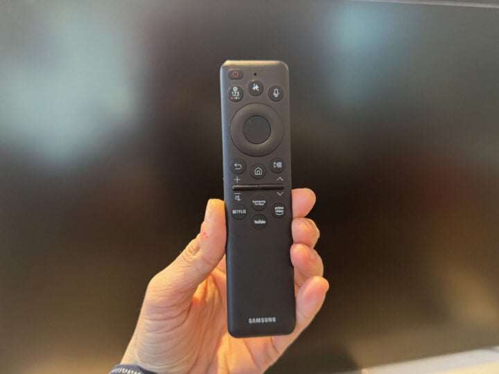 Hand holding a Samsung TV remote