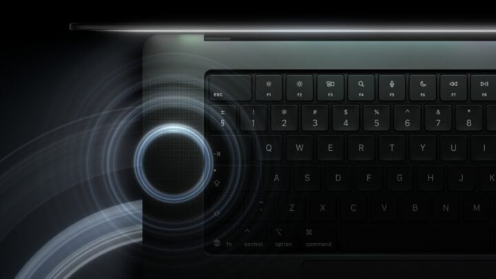 Close-up of the MacBook Pro keyboard and speaker grille with a sound wave graphic