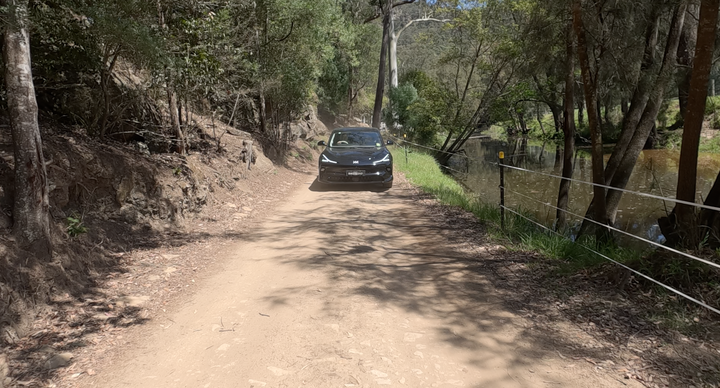 Mission 1 Pro footage of a car on a dusty road.